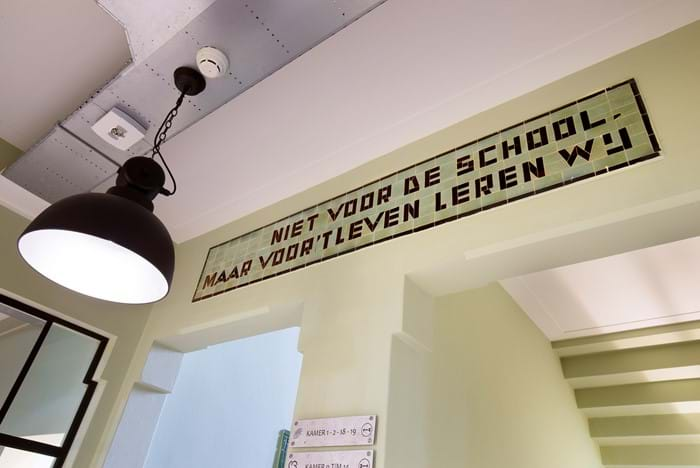 tekst op muur "niet voor de school maar voor 't leven leren wij"